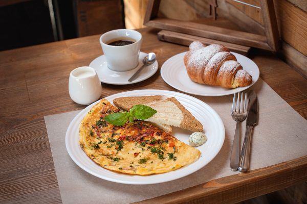 breakfast. Omelet with greens, croissant and coffee