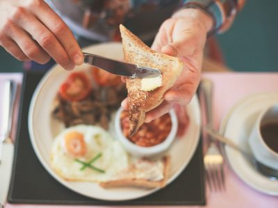 Closeup on a young woman's hands as she is having breakfast